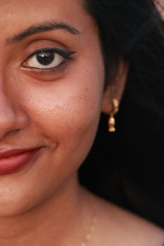Close-up of a smiling Indian woman with healthy skin
