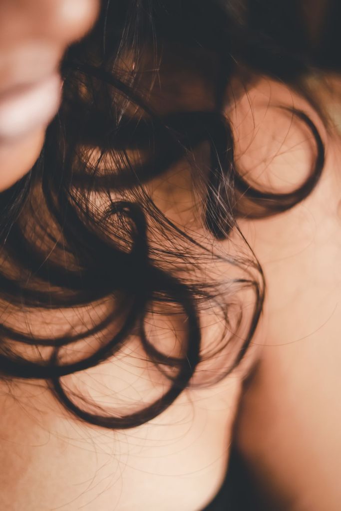 Close-up of dark, healthy curly hair